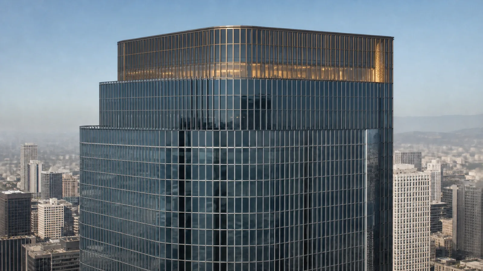 The crown and upper floors of Grand Forum Tower illuminated above Los Angeles.